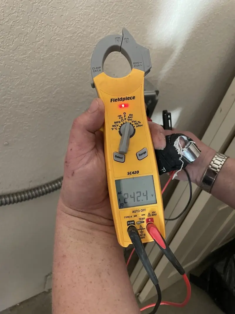 Voltage testing with clamp meter during Whole House Surge Protector in East Liverpool